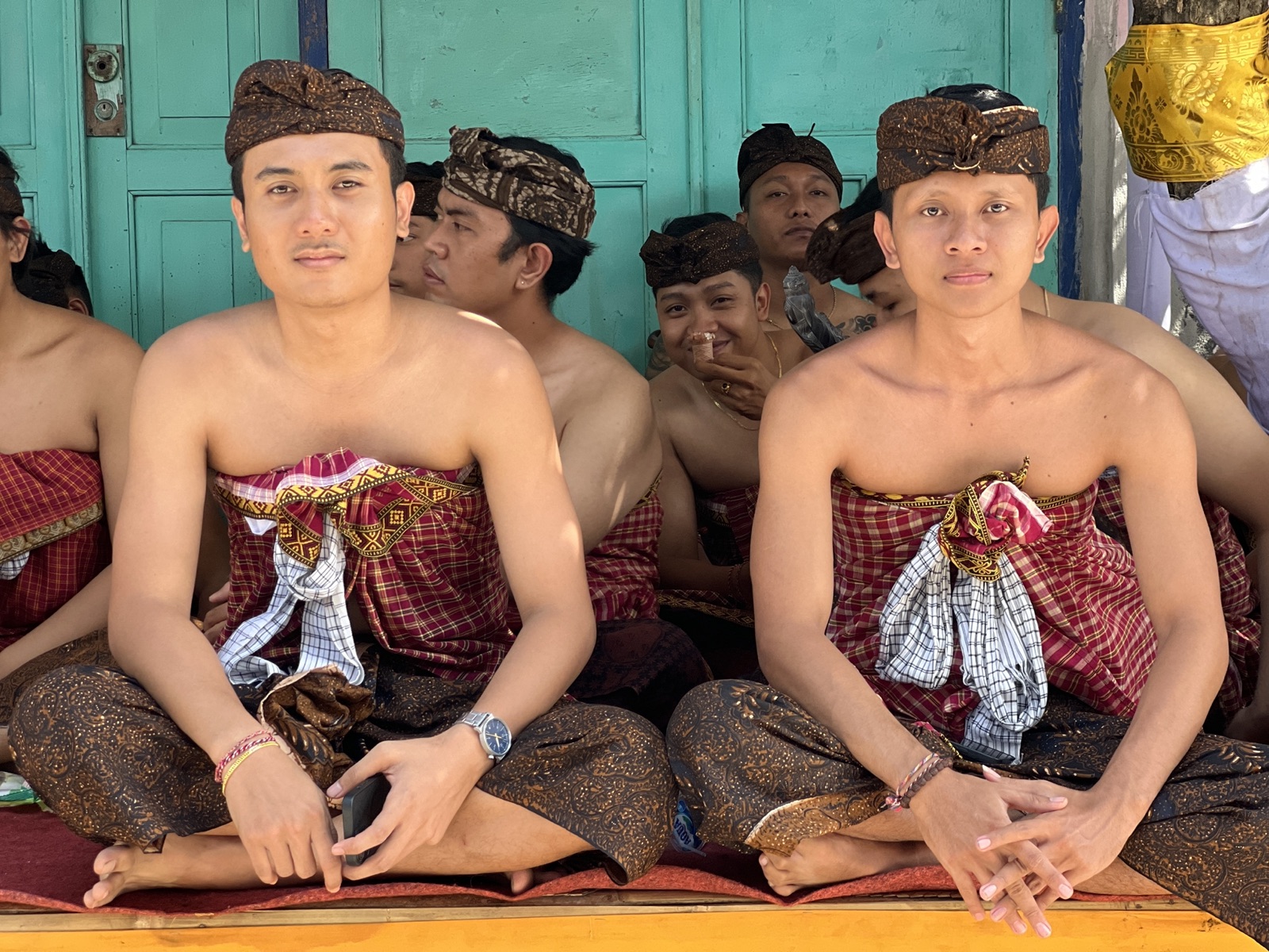 Young men preparing in traditional Balinese dress