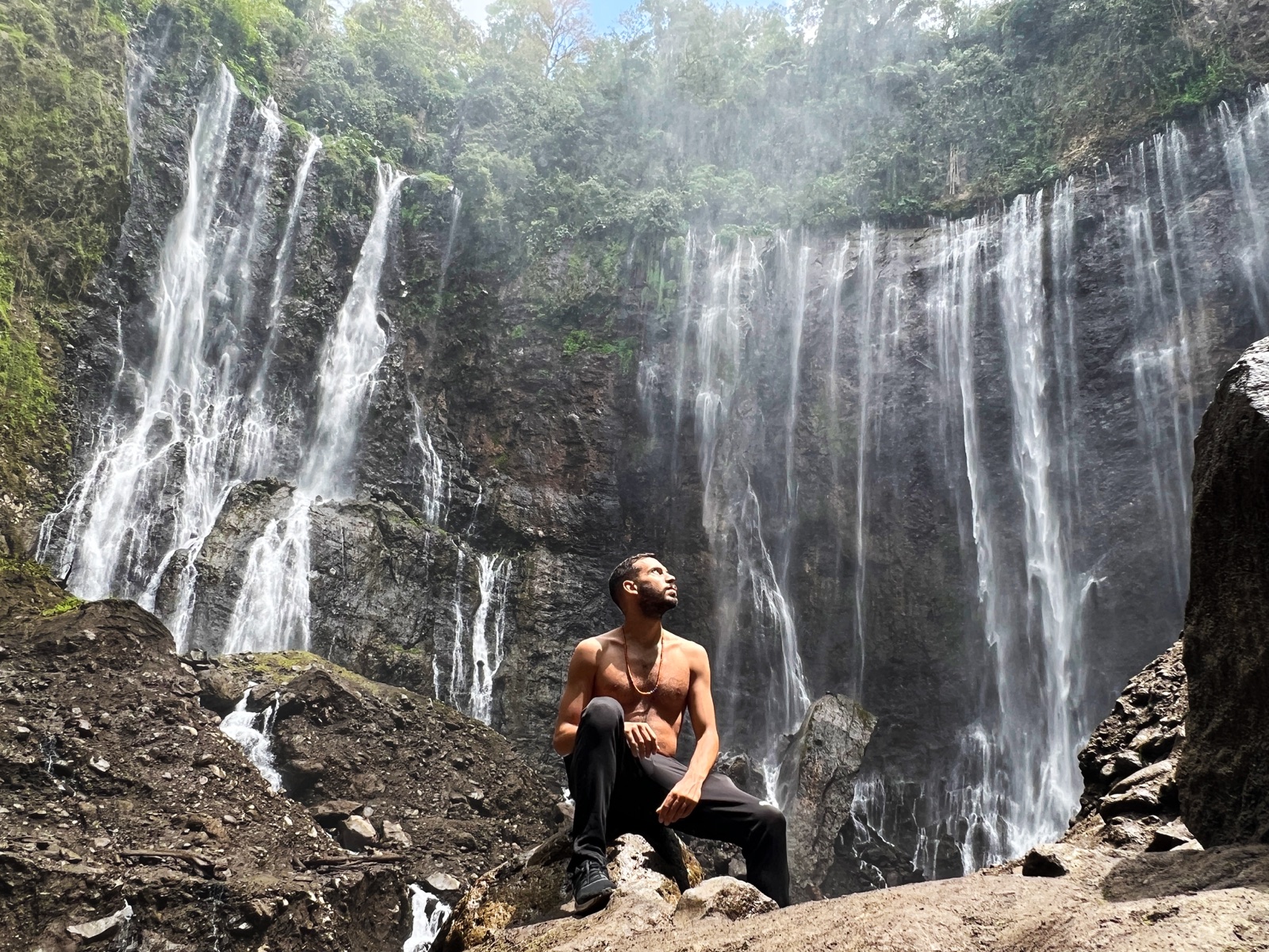 Filippo beneath a waterfall in Indonesia