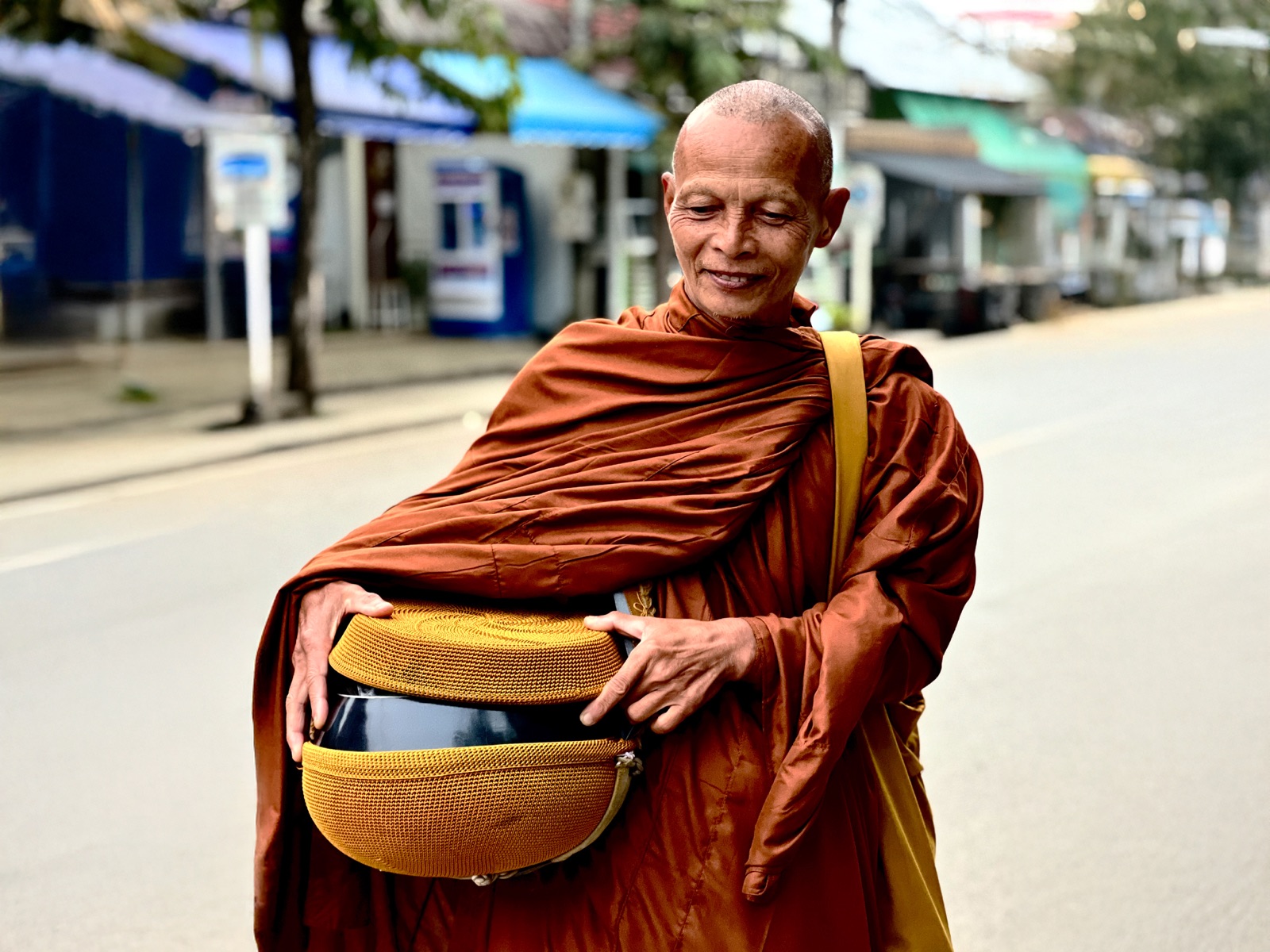 Monk collecting food and offerings in Pai